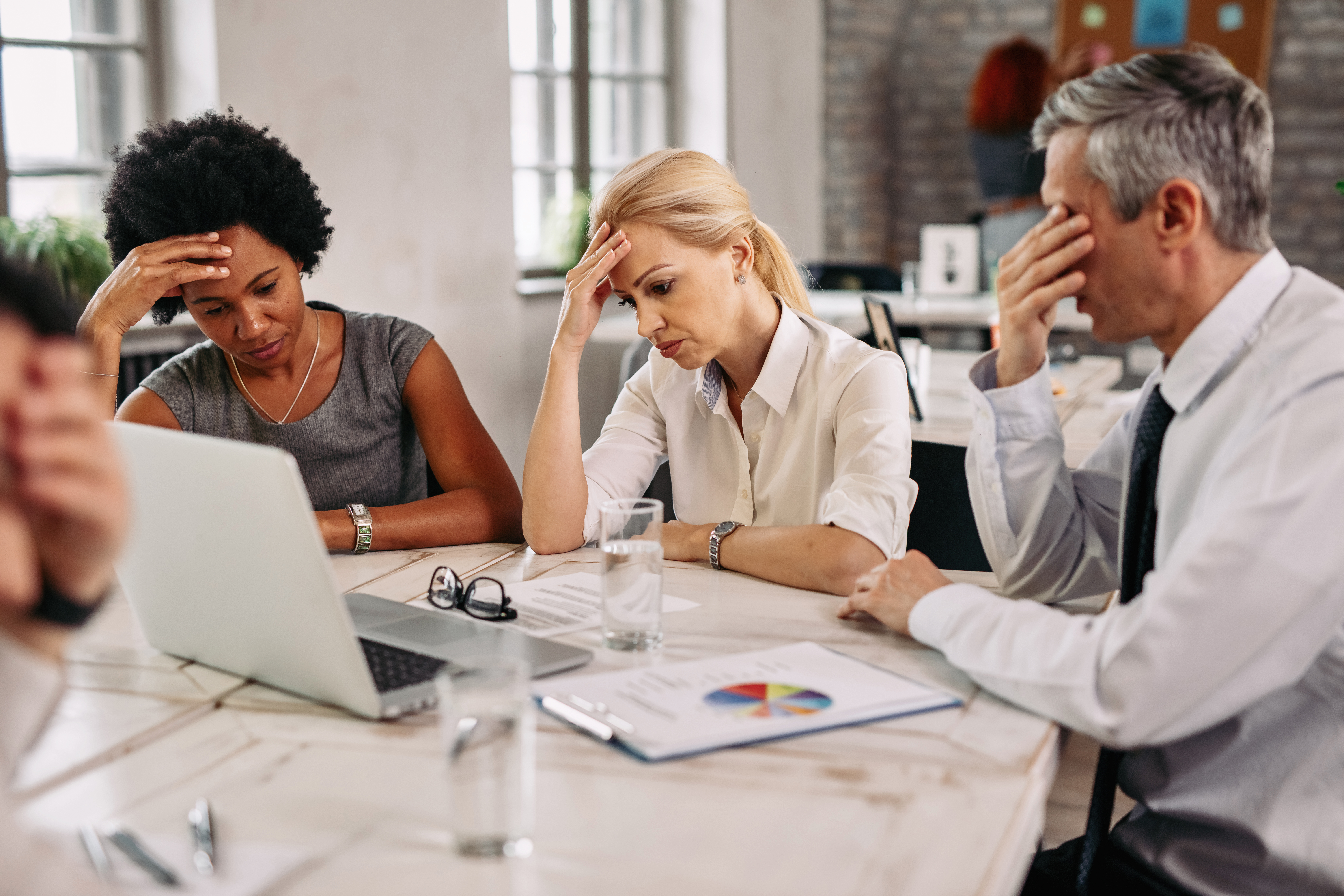 Frustrated team looking at a laptop